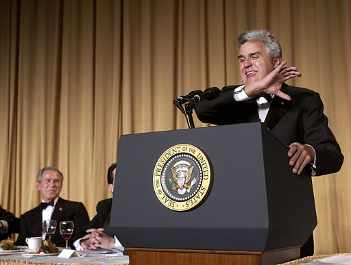 Comedian and TV host Jay Leno delivers a monologue as President George W. Bush listens at the annual White House Correspondents Association Dinner, Washington, May 1, 2004
