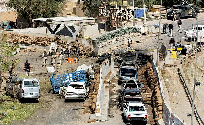 A bomb exploded at a crowded intersection where cars lined up to be searched at a military checkpoint, Baghdad, May 6, 2004.
