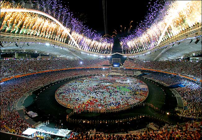 Fireworks explode over the main Olympic stadium during the Athens 2004 Olympic Games opening ceremony, August 13, 2004.