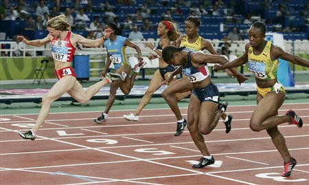 Yuliya Nesterenko, left, of Belarus wins the gold medal in the 100-meter sprint with a time of 10.93 seconds, Lauryn Williams, second from right, of the United States won the silver, and Veronica Campbell, right, of Jamaica, took the bronze, at the 2004 Olympic Games, Athens, Greece, August 21, 2004.