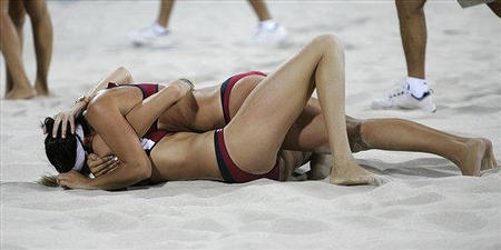 USA's Kerri Walsh, bottom, and teammate Misty May celebrate after beating Brazil in the gold medal beach volleyball finals during the 2004 Olympic Games at Faliro Beach Volleyball Stadium, Athens, Greece, August 24, 2004.