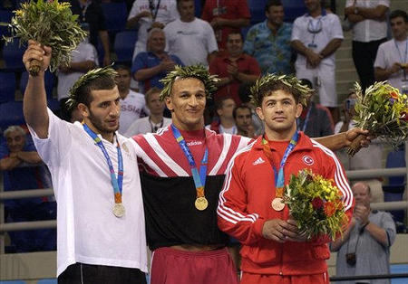 Karam Gaber Ibrahim of Egypt, gold, Ramaz Nozadze of Georgia, silver, left, and Mehmet Ozal from Turkey, bronze, are the winners of the for Men's Greco-Roman 96kg wrestling final at the 2004 Olympic Games, Athens, August 26, 2004. 