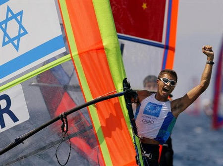 Israel's Gal Fridman celebrates as he crosses the finish line of the Men's Mistral windsurfer sailing event at the 2004 Olympic Games in Athens and winnig the first Gold medal for Israel at the Olympic Games ever, Athens, August 25, 2004. 