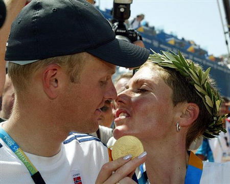 Norway's Gunn Rita Dahle kisses her coach Kenneth Flesjaa after she won the gold medal in the women's mountain bike race of the 2004 Olympic Games, outskirts of Athens, August 27, 2004.