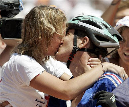 France's Julien Absalon kisses his wife Emilie after the Men's Mountain Bike race of the 2004 Olympic Games, outskirts of Athens, August 28, 2004.