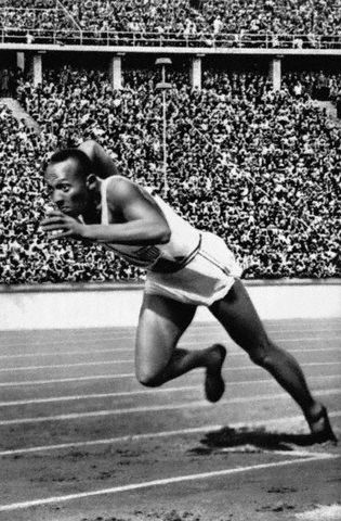 Jesse Owens dashes to Olympic victory in 200 meters, August 5, 1936.