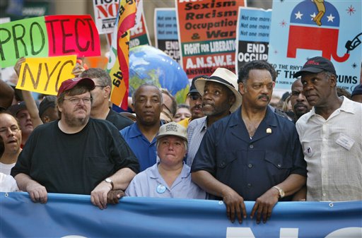 Filmmaker Michael Moore, protest organizer Leslie Cagan, the Rev. Jesse Jackson, and actor Danny Glover, lead a protest march by tens of thousands of Bush administration opponents on the eve of the Republican National Convention in New York, August 29, 2004.