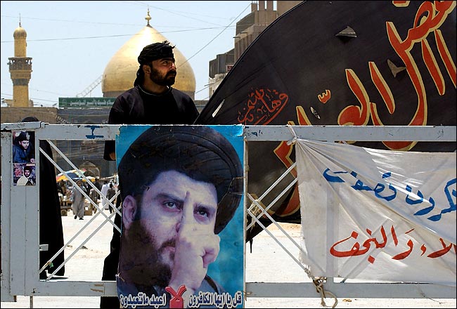 A follower of Moktada al-Sadr continued to guard a checkpoint near the Imam Ali shrine in Najaf after the truce agreement with American forces, July 2004.
