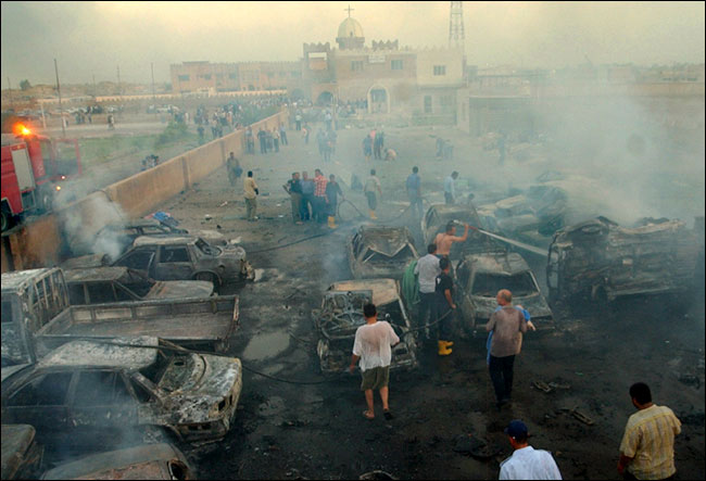 Iraqis examined the Doura neighborhood in southern Baghdad after two cars loaded with explosives blew up in a seminary compound, August 1, 2004.