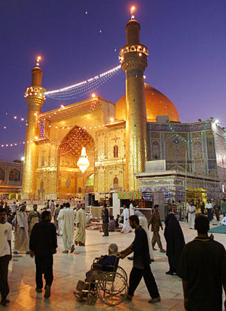 Iraqis walk through the courtyard of Najaf's Imam Ali shrine during a ceasefire, August 26, 2004.