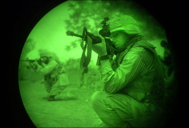 Special Operations Forces, seen through night-vision optics, surrounded a village compound in Afghanistan, September 2002.
