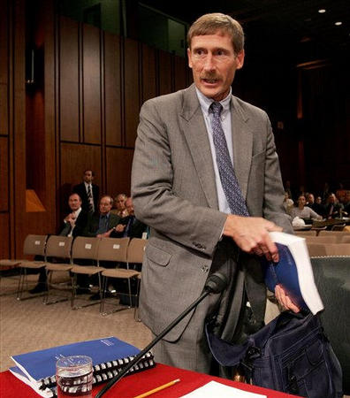 Charles Duelfer, head of the Iraq Survey Group, pulls out his report on the state of the Iraqi weapons of mass destruction program before the start of a Senate Armed Services committee hearing, Washington, October 6, 2004.