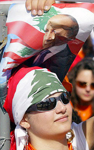 A supporter of Lebanon's Christian opposition leader Michel Aoun holds his picture during a rally welcoming his return from exile, Martyrs' Square, Beirut, May 07, 2005.