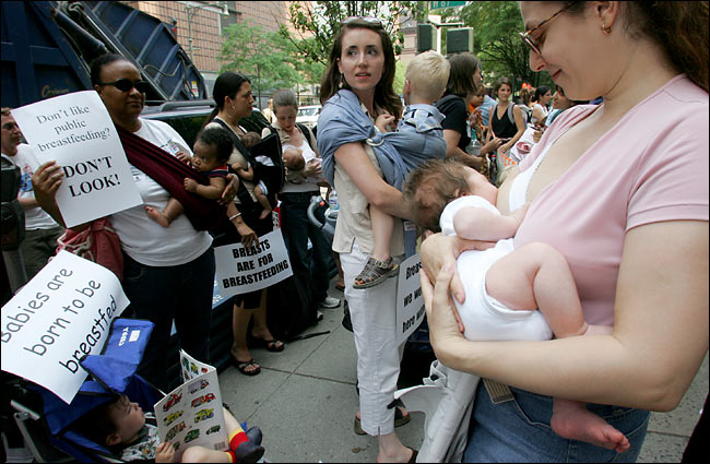 Tamara Tsoutsouris, right, feeding her 7-week-old during the 'nurse-in' rally that brought about 200 women to ABC's headquarters as part of a protest over earlier remarks by Barbara Walters, New York, June 6, 2005.