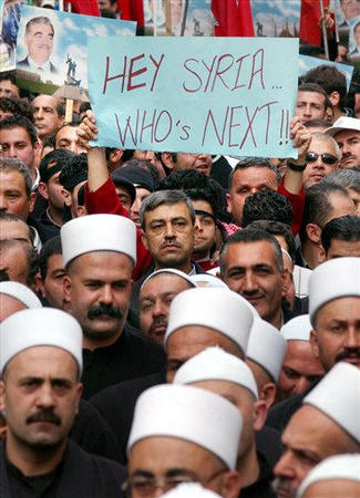 Supporters of former Lebanese Prime Minister Rafiq Al-Harari walk during his funeral procession in Beirut, Lebanon, February 16, 2005.