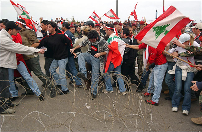 Lebanese security forces put out razor wire to control the crowd in Beirut, Lebanon, February 28, 2005.