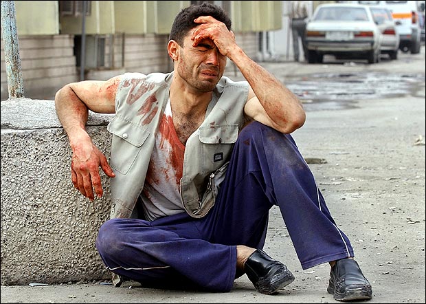 A man whose brother was seriously injured by a suicide car bomb weeps outside al-Kindi hospital, Baghdad, March 4, 2005.