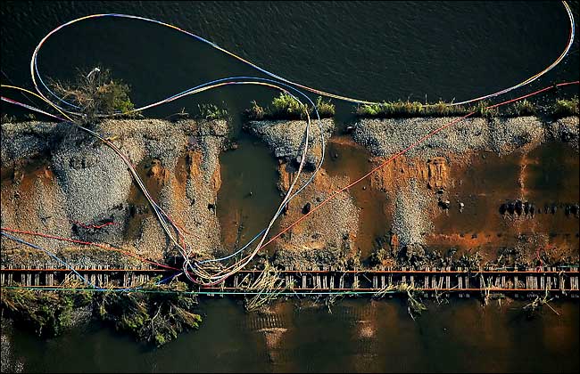 Electrical wires, which once ran parallel to train tracks outside New Orleans, lie twisted after the Hurricane Katrina, September 2005.