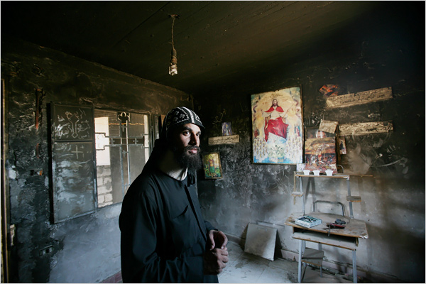 A monk, wearing a neck brace because of injuries he sustained, is seen in a room that was badly damaged 2 months earlier in an apparent attack at a monastery in Abu Fana Monastery, about 300 kilometers south of Cairo, late July 2008.
