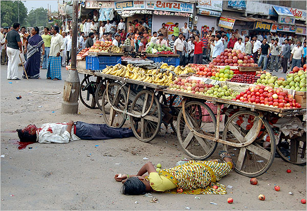 Two people lay wounded at the site of one of at least 16 blasts in Ahmedabad, India, July 26, 2008.