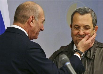 Israeli Prime Minister Ehud Olmert, left, jokes with Israeli Defense Minister Ehud Barak, at a press conference following a meeting of the security cabinet at the Defense Ministry, Tel Aviv, January 17, 2009.