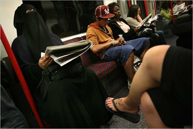 A woman identified only as Ms. Shaikh takes the subway to meet her husband, only to receive rude comments about her niqab, as from a woman at her workplace who told her she had no right to be there, London, June 2007.