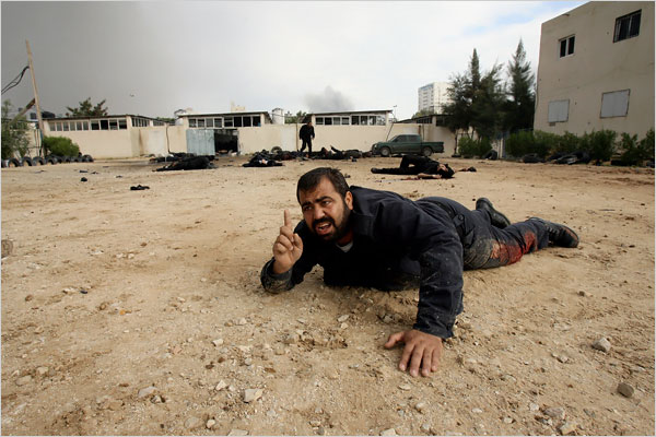 An injured man struggls at the Hamas police headquarters as hundreds of Palestinians are also killed and scores more wounded in the first hour of Israel’s massive attack on about 100 Hamas sites throughout Gaza in retaliation for the recent rocket fire from the area, Gaza, December 27, 2008.
