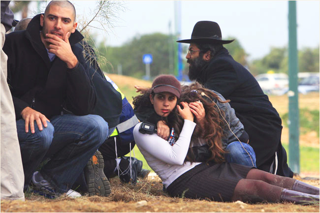 On the third day of Israel’s massive attack on Hamas sites throughout Gaza in retaliation for the recent rocket fire from the area, Israelis take cover during a rocket warning siren in the southern Israeli town of Ashkelon, where a rocket fired from Gaza killed an Arab man and wounded seven this day, December 29, 2008.