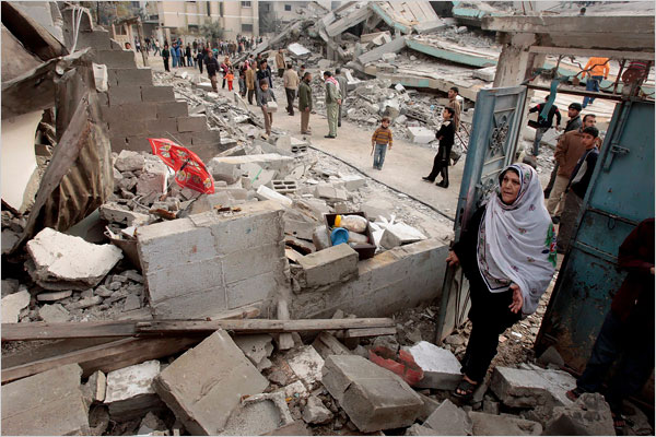 On the thirteenth day of Israel’s war against Gaza, a Palestinian woman looks at her house, which was destroyed in an Israeli air strike, January 8, 2009.