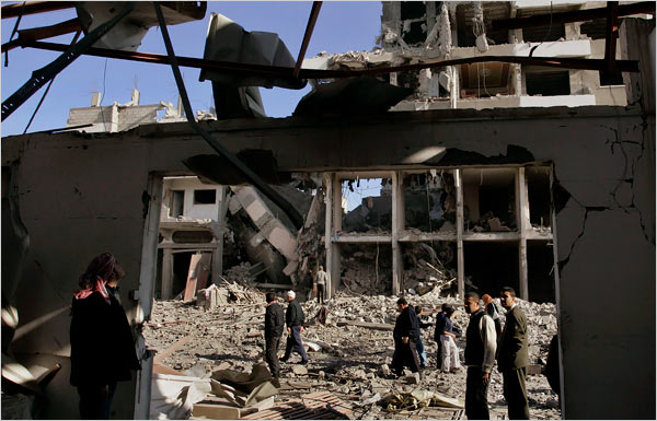 On the eighteenth day of Israel’s war against Gaza, Palestinians survey the damage to a building following an Israeli airstrike, Gaza City, January 13, 2009.
