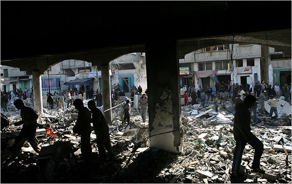 On the eighteenth day of Israels war against Gaza, Palestinians inspect rubble at al-Abrar mosque, one of the sites struck in the overnight Israeli raids on Rafah, January 13, 2009.