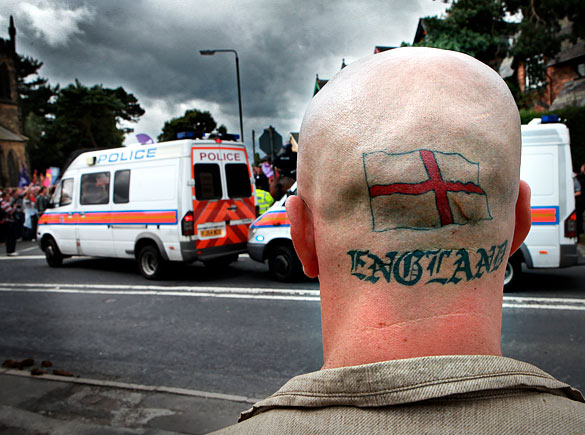 A man watches protesters demonstrating against the BNP’s annual Red, White and Blue festival, near Codnor village, Derbyshire, England, August 15, 2009.
