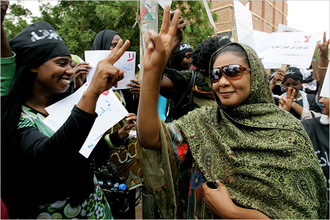 Lubna Hussein the Sudanese journalist and former United Nations worker, who is trialed of 'indecent dressing,' for wearing trousers in public, a charge that could lead her to being flogged with 40 lashes, with her supporters gathering outside the court upon her arrival for a hearing, Khartoum, September 5, 2009.