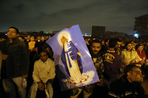 Egyptians gather outside the Virgin Mary church in Cairo's al-Warraq district for expected Virgin Mary apparitions, mid December 2009.