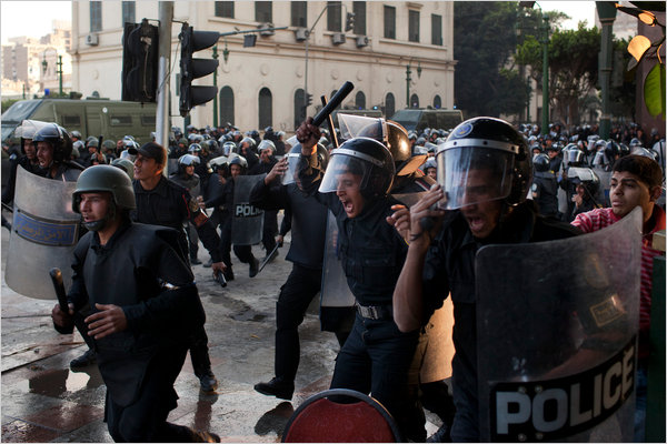 Riot police officers rush to confront instigators led by the Muslim Brotherhood underworld gang, downtown Cairo, Egypt, minutes after midnight, late January 25, 2011.
