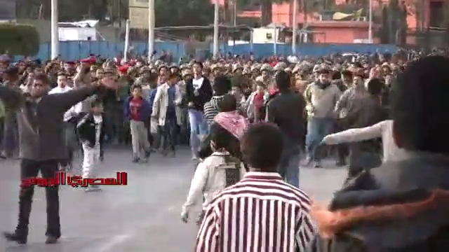 Ordinary Egyptian people, along with Armed Forced and Police in civilian dress, storm A-Tahrir Square to evacuate it from Arab minority invaders, downtown Cairo, Egypt, March 9, 2011.