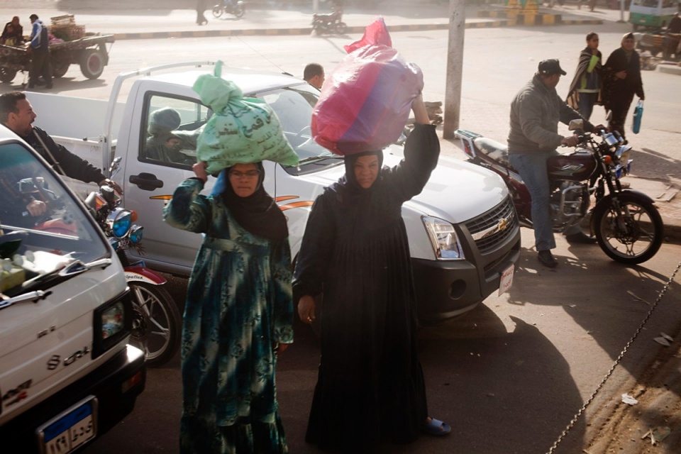 Women wait for the train to pass, rural Giza, early February 2011.