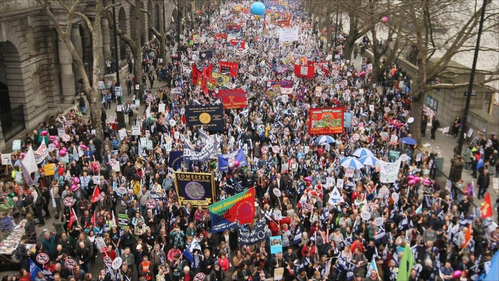Protesters including teachers, nurses and council workers, waving placards with slogans opposing cuts to services and job losses, join the March for the Alternative against government spending cuts, which arranged by The Trades Union Congress (TUC), and started at Victoria Embankment, London, March 26, 2011.