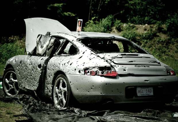140 members of the local gun club, Massachusetts club Comm2A, fire 10,000 bullets into a Porsche 911, donated by a wealthy motorist was so fed-up with the car's constant engine problems, that by the end of the shoot, the Porsche was so perforated that it was folding in half under its own weight, June 20, 2011.