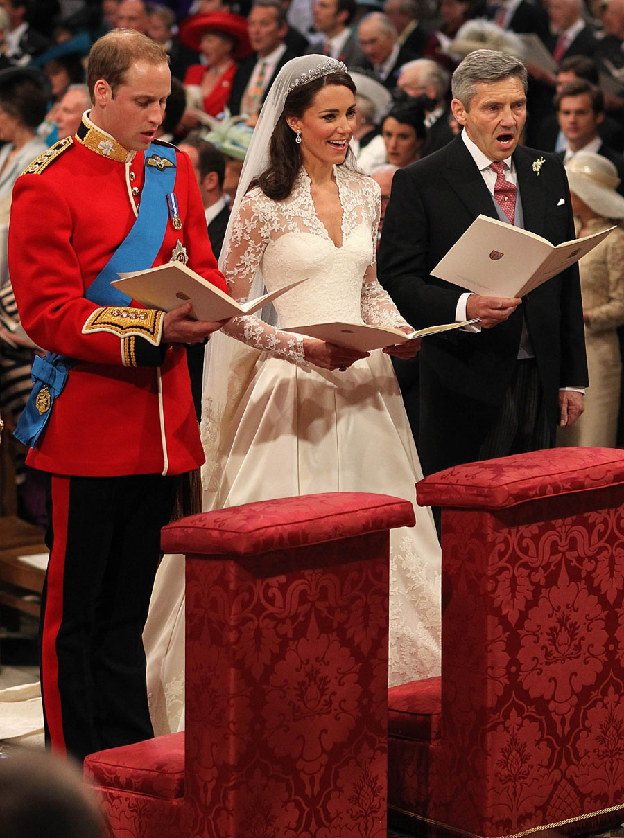 Britain's Prince William and Catherine Middleton, Duchess of Cambridge, and Kate's father Michael Middleton, sing during the Royal Wedding Ceremony, Westminster Abbey, Central London, April 29, 2011.