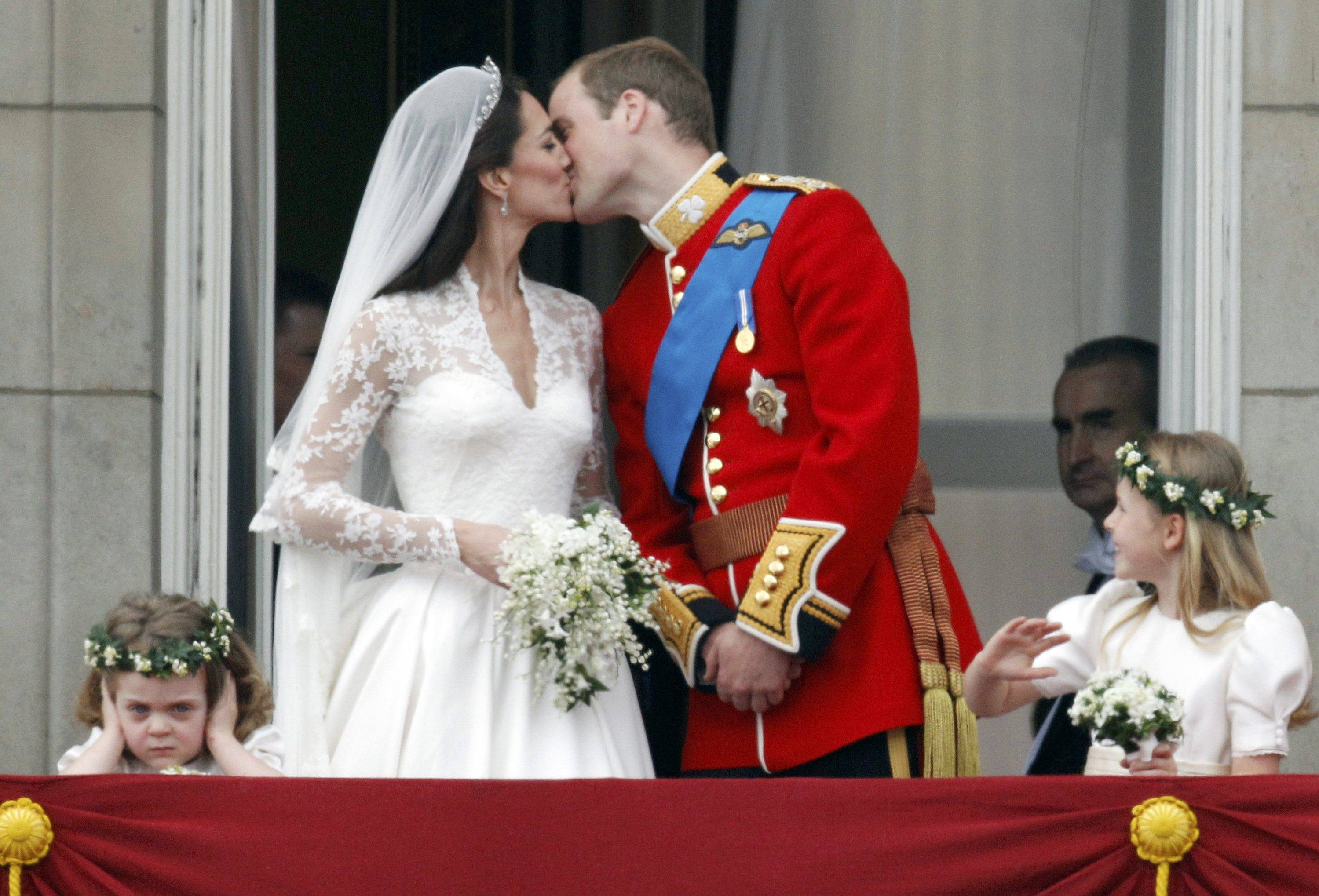 The magical moment said the entire world has been waiting on for most of this year finally occurrs as Britain's Prince William and Catherine Middleton, Duchess of Cambridge, kissed twice on the balcony of Buckingham Palace in front of family and ecstatic crowds welcoming the newest royal couple in what was described as the most fabulous ceremony for the world to see in a very long time, make the 3-year-old Miss Grace van Cutsem protects her ears to avoid roar while the other bridesmaid Margarita Armstrong-Jones looks in, Central London, April 29, 2011.