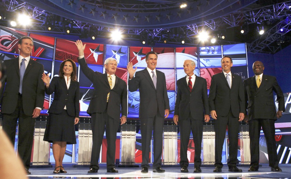 Republican presidential hopefuls (L-R) former U.S. Senator Rick Santorum (R-PA), U.S. Rep. Michelle Bachmann (R-MN), former Speaker of the U.S. House of Representatives Newt Gingrich (R-GA), former Massachusetts Governor Mitt Romney, U.S. Rep. Ron Paul (R-TX), former Minnesota Governor Tim Pawlenty and former Godfather's Pizza CEO Herman Cain pose at the first New Hampshire debate of the 2012 campaign at St. Anslems College, Manchester, New Hampshire, June 13, 2011.