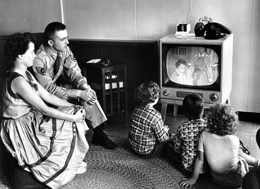 As the color television was just introduced in the U.S. in March 25, 1954 by Radio Corporation of America, a serviceman views the traditional B&W television with his family at the U.S. Limestone, Maine, base, July 1, 1954.