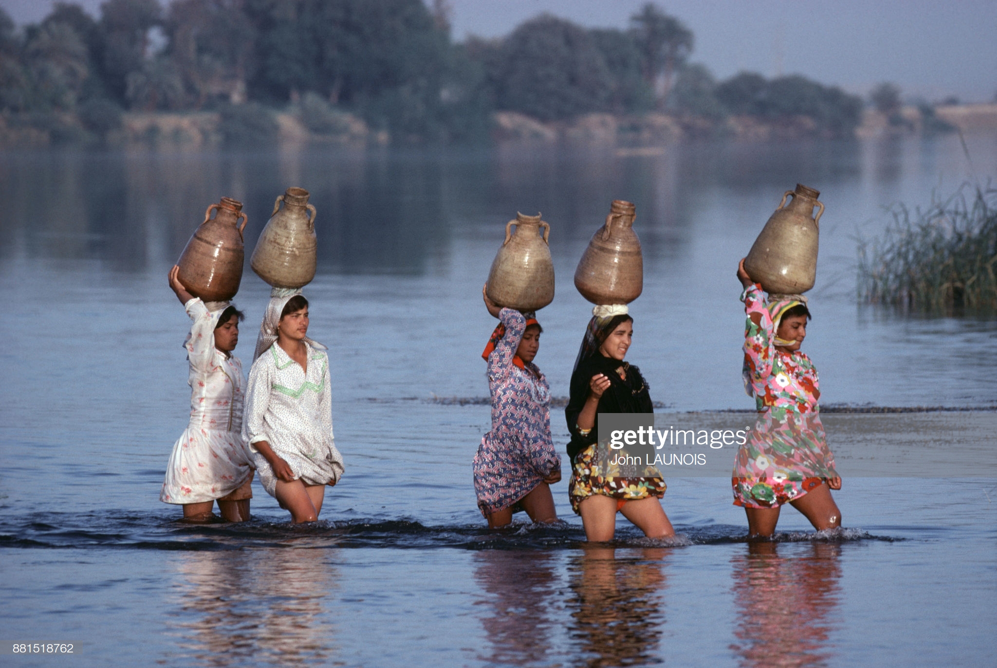 Egyptian young women crossing a waterway, circa 2015.