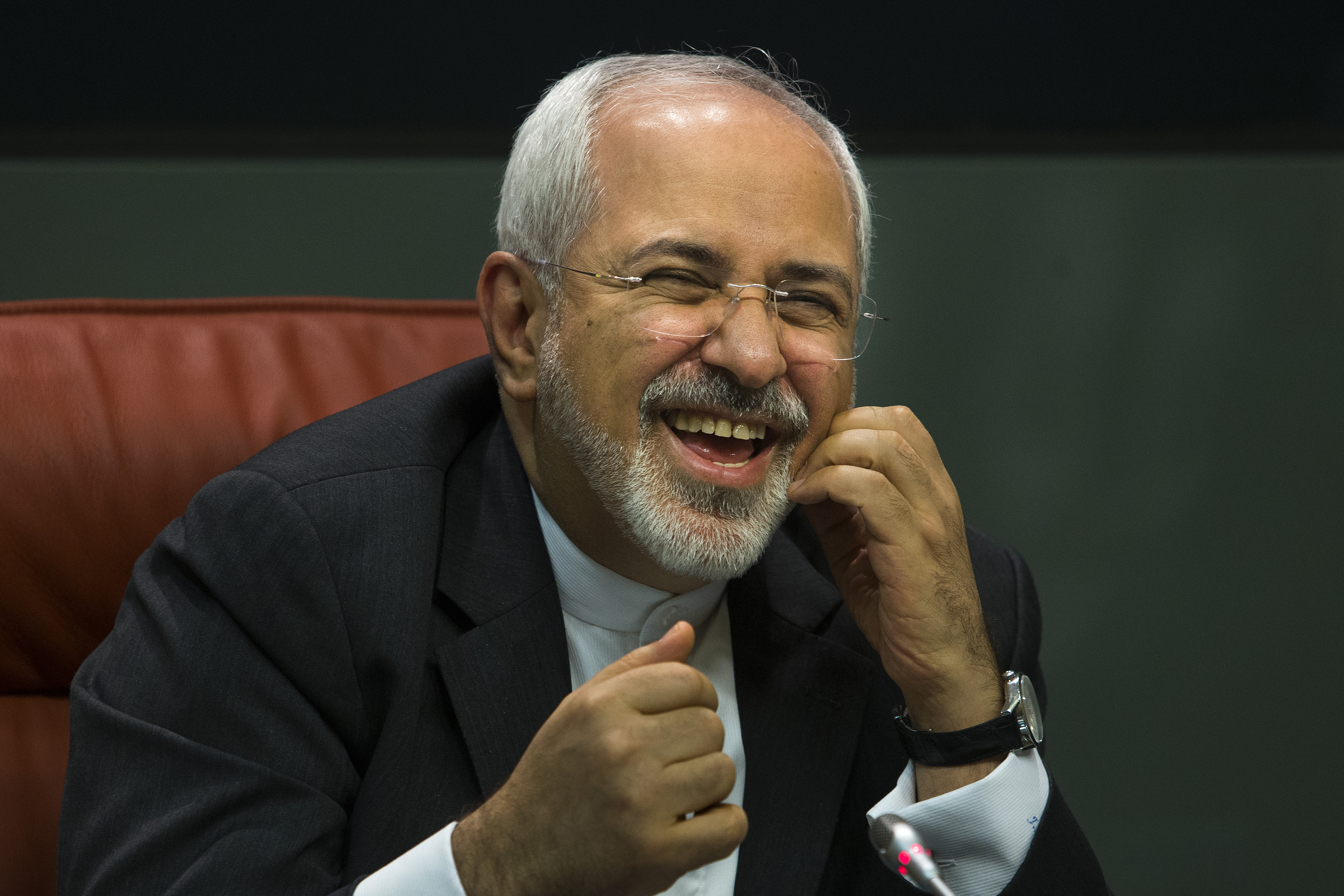 Iranian Foreign Minister Mohammad Javad Zarif laughs during a press conference with his Spanish counterpart Manuel Garcia Margallo, Madrid, Spain, April 14, 2015.