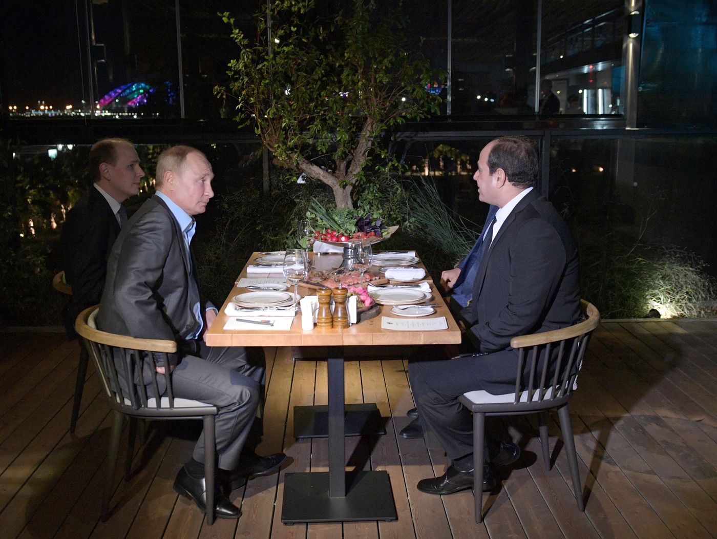 Russian President Vladimir Putin, left, and Egyptian President Abdel-Fattah el-Sisi eat dinner in a restaurant on embankment of the Olympic Park in Sochi, Russia, October 16, 2018.